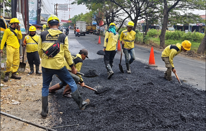 Perbaikan jalan berlubang di Jalan Raya Cadas Periuk, Kota Tangerang.